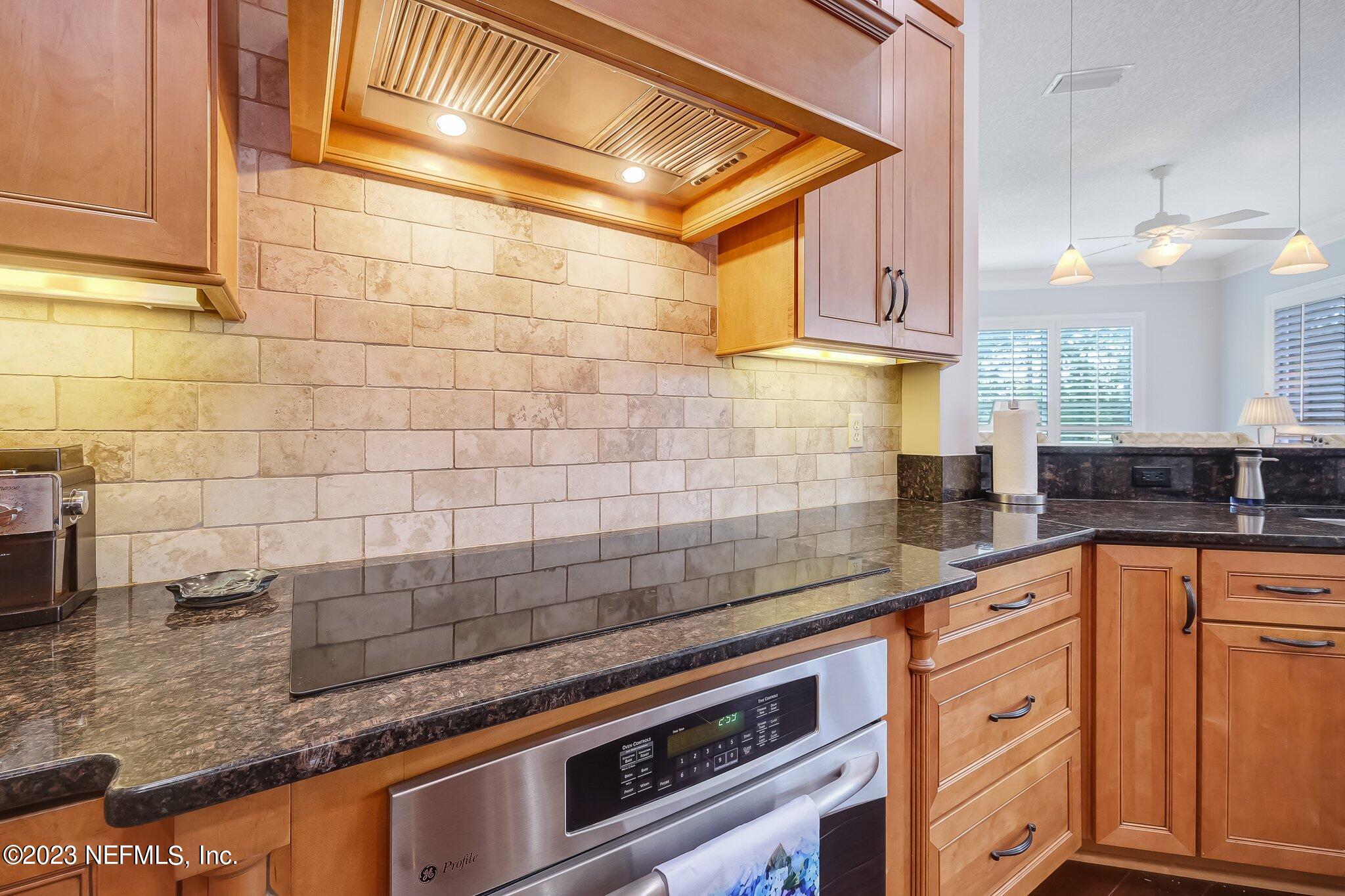 8026 Pine Lake Road Jacksonville, FL 32256 - Photo 14 of 43 a kitchen with stainless steel appliances granite countertop a sink and cabinets