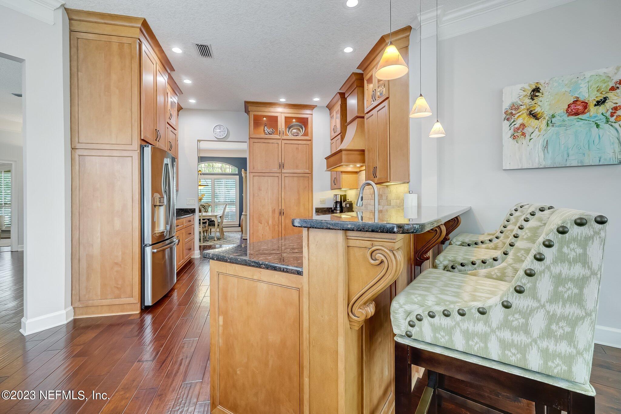 8026 Pine Lake Road Jacksonville, FL 32256 - Photo 15 of 43 a view of kitchen with furniture and wooden floor