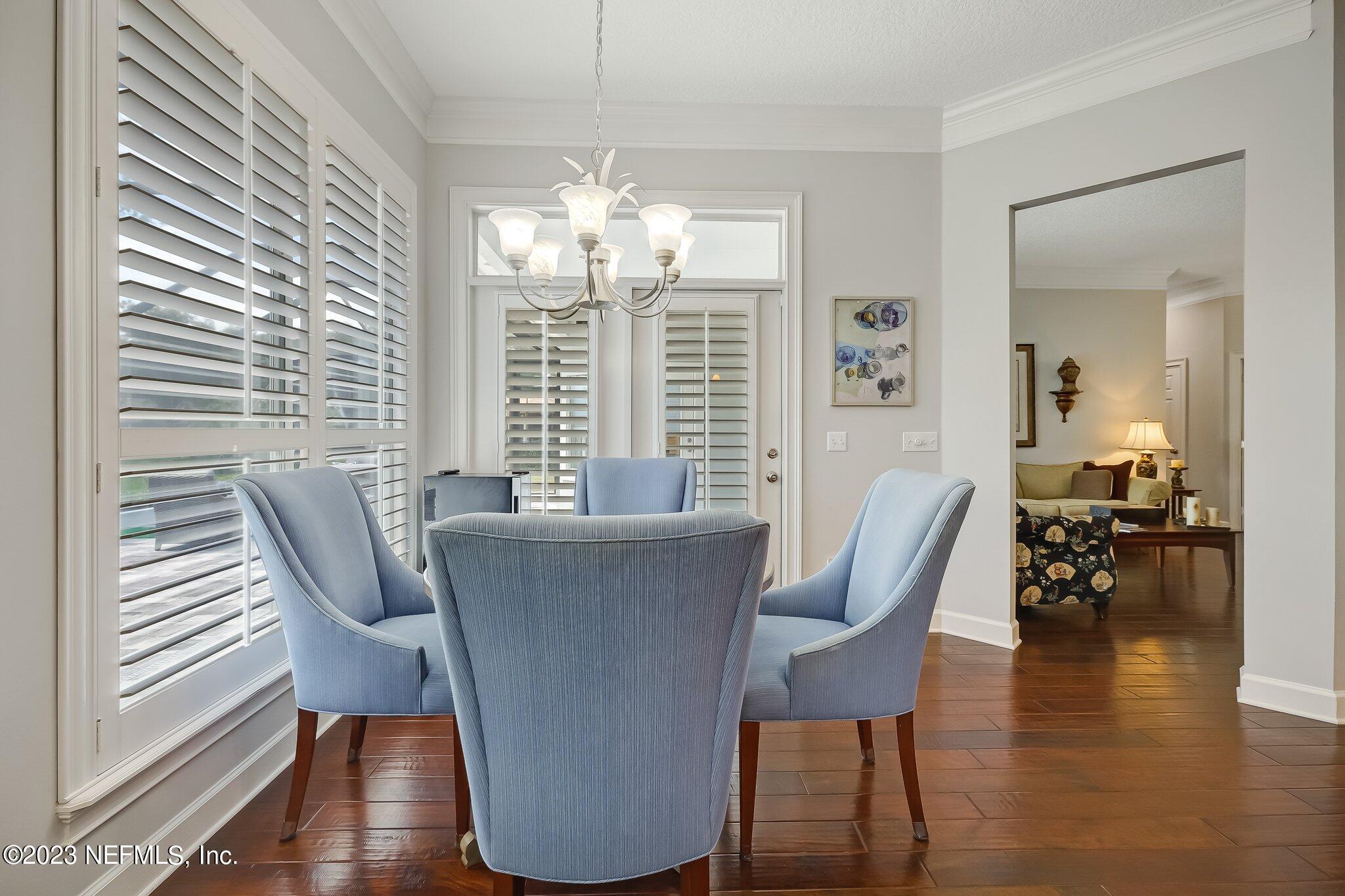 8026 Pine Lake Road Jacksonville, FL 32256 - Photo 16 of 43 a view of a dining room with furniture wooden floor and chandelier