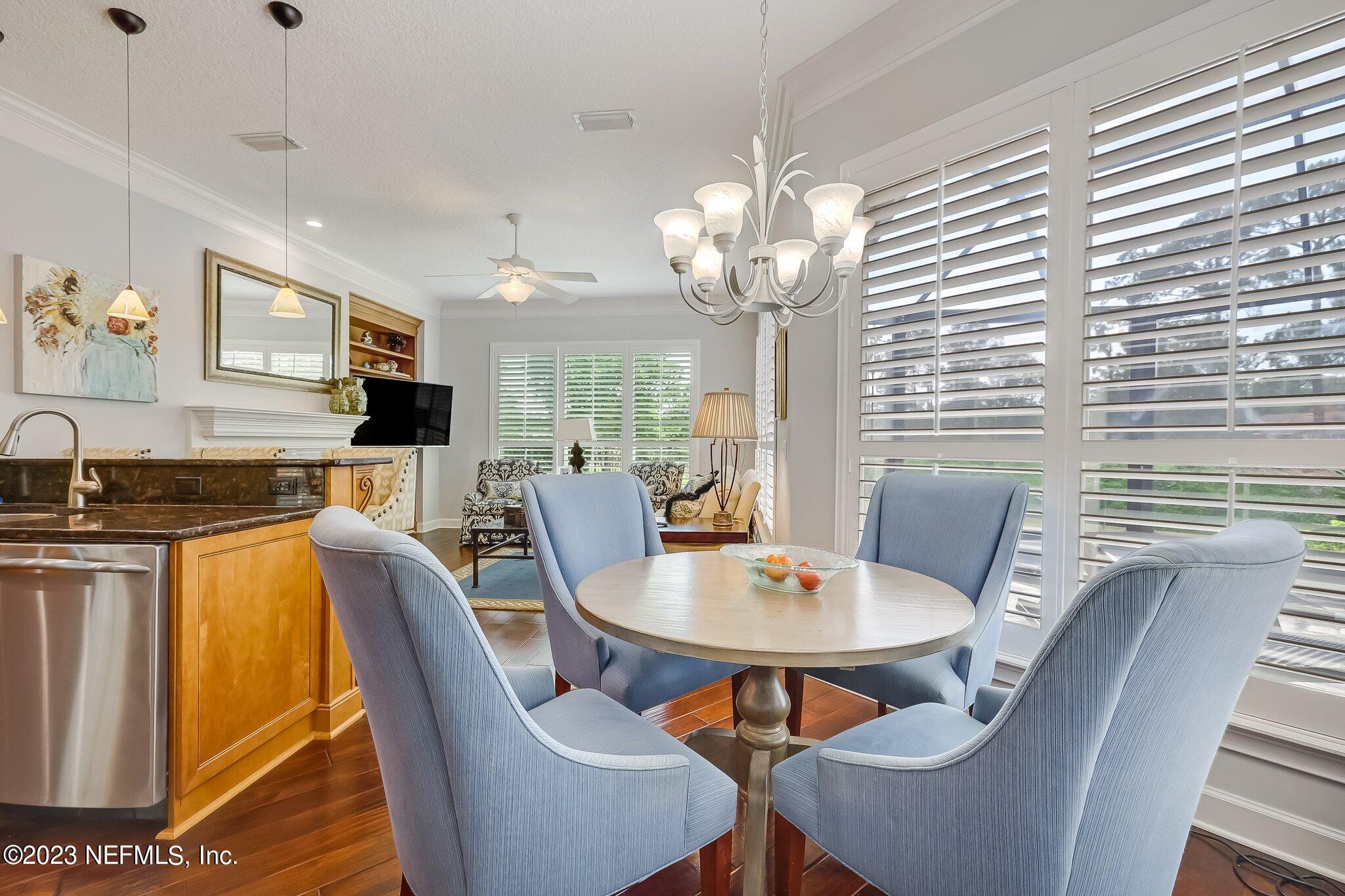 8026 Pine Lake Road Jacksonville, FL 32256 - Photo 17 of 43 a view of a dining room with furniture a chandelier and wooden floor