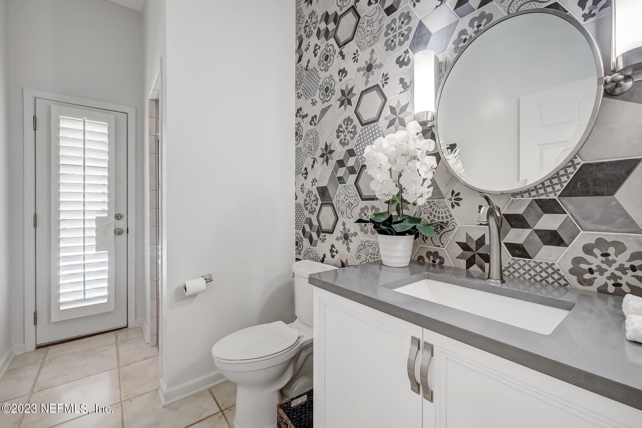 8026 Pine Lake Road Jacksonville, FL 32256 - Photo 21 of 43 a bathroom with a sink toilet and mirror