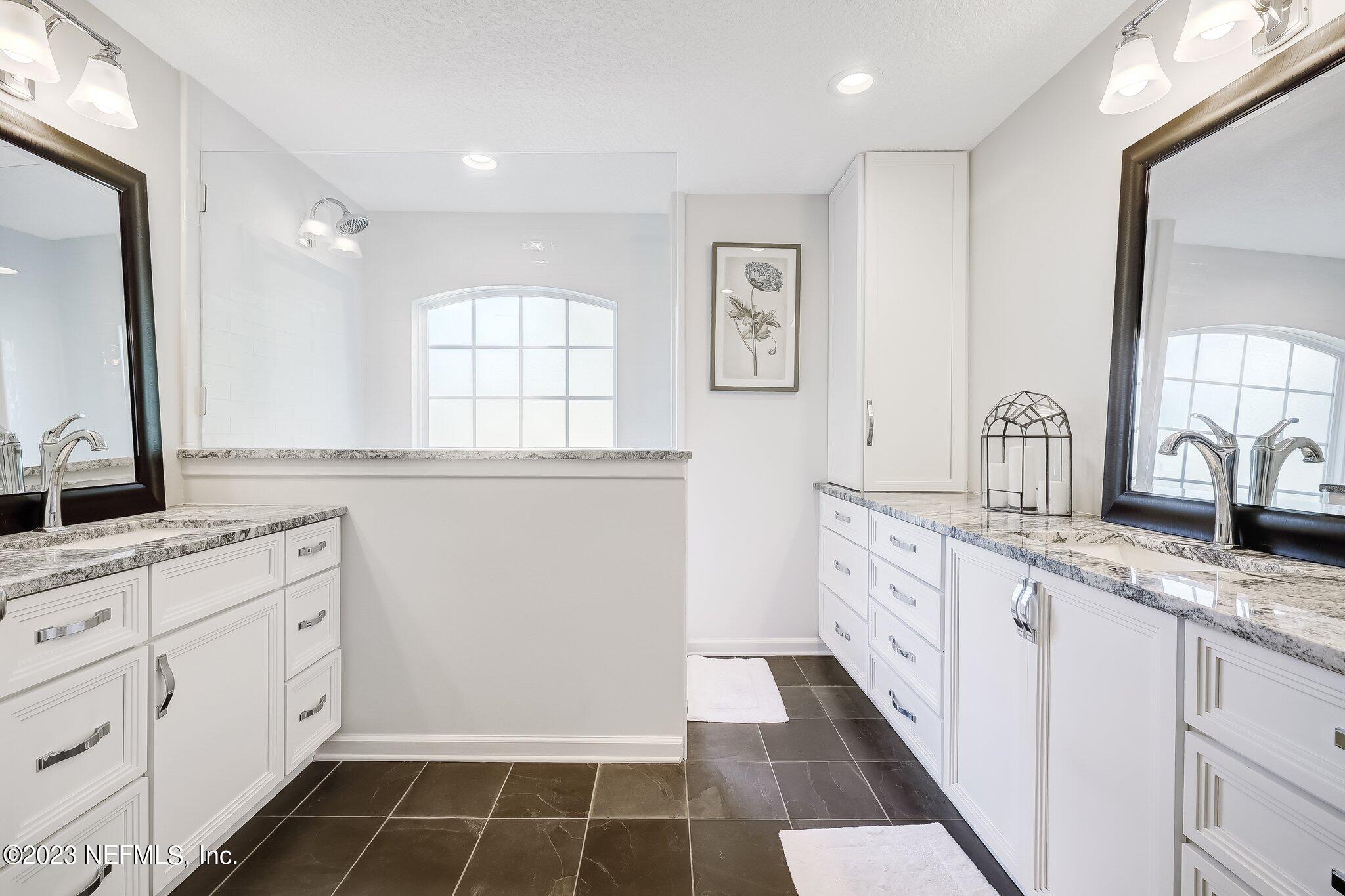 8026 Pine Lake Road Jacksonville, FL 32256 - Photo 24 of 43 a kitchen with granite countertop white cabinets and white appliances
