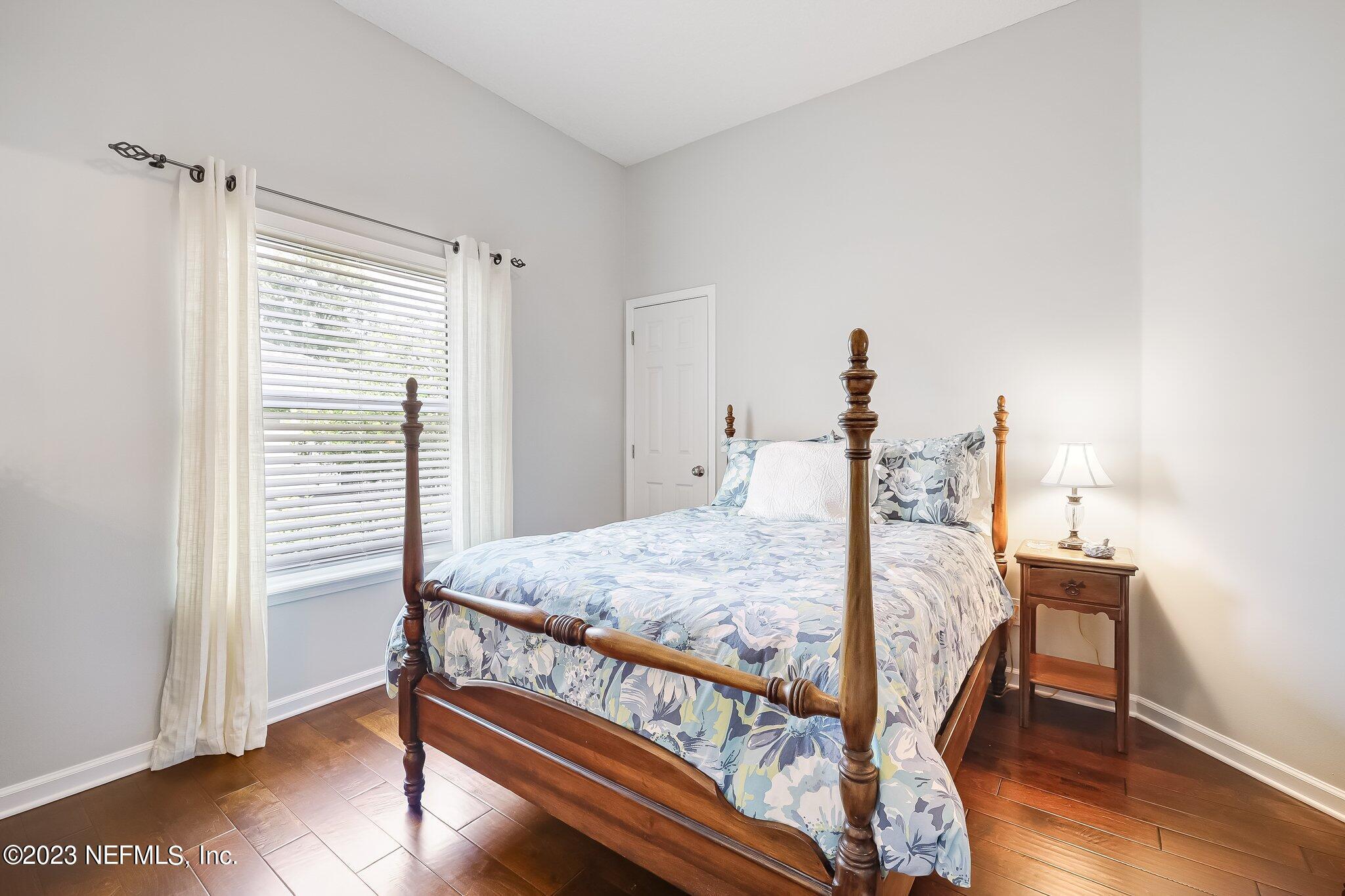 8026 Pine Lake Road Jacksonville, FL 32256 - Photo 25 of 43 a bedroom with a bed and wooden floor