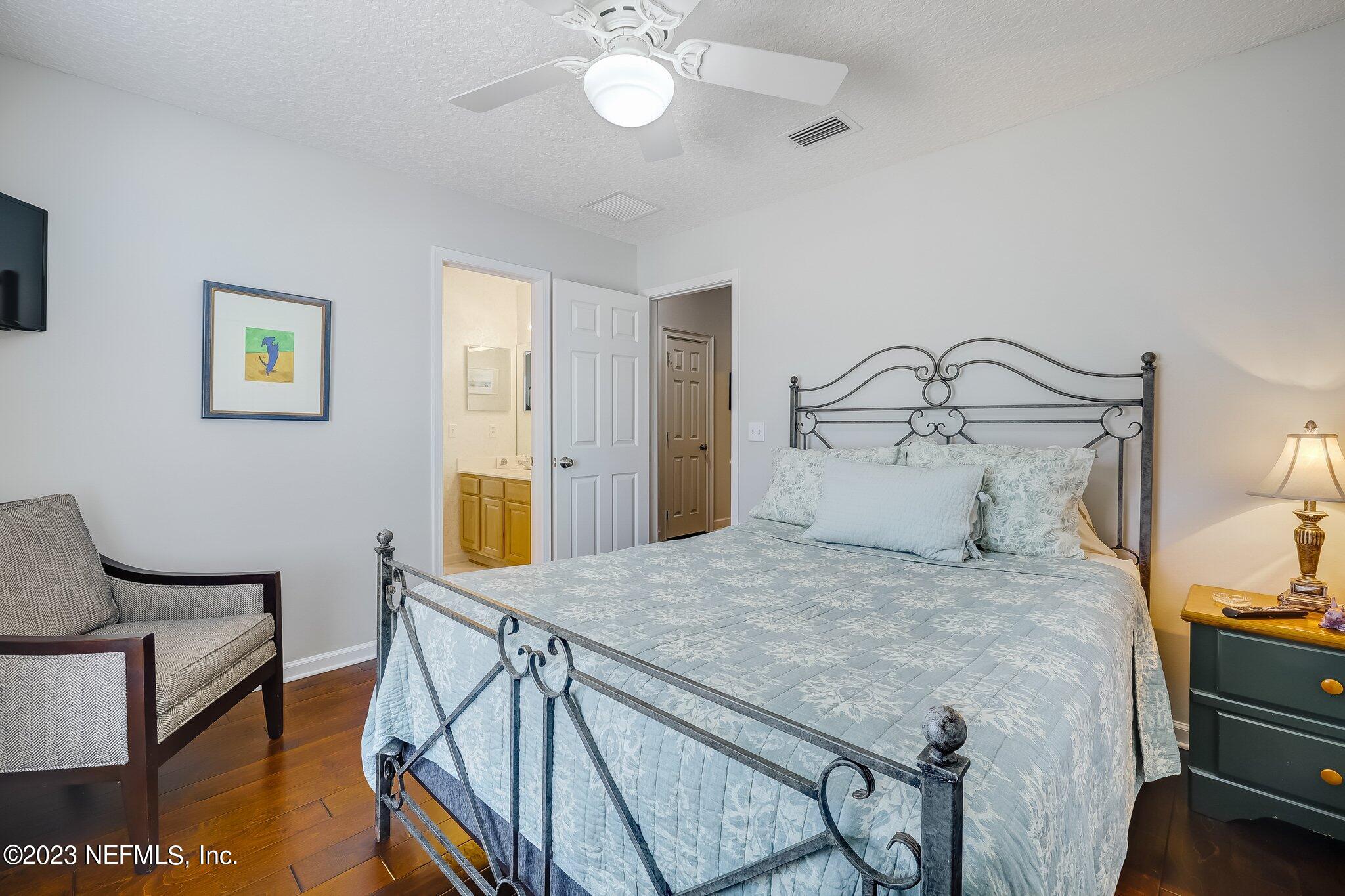 8026 Pine Lake Road Jacksonville, FL 32256 - Photo 26 of 43 a bedroom with a bed and table chair