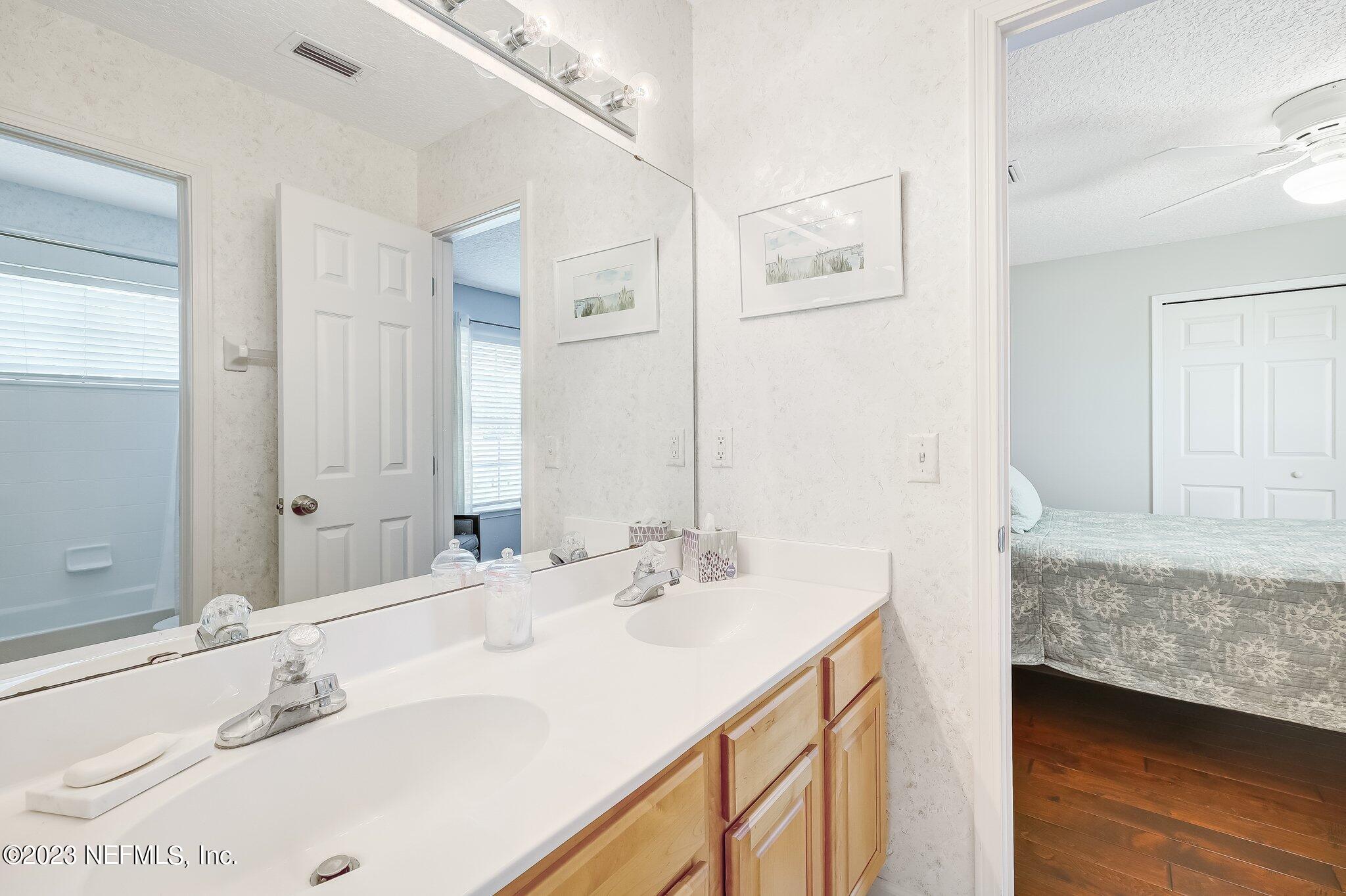 8026 Pine Lake Road Jacksonville, FL 32256 - Photo 27 of 43 a bathroom with a sink double vanity and a mirror
