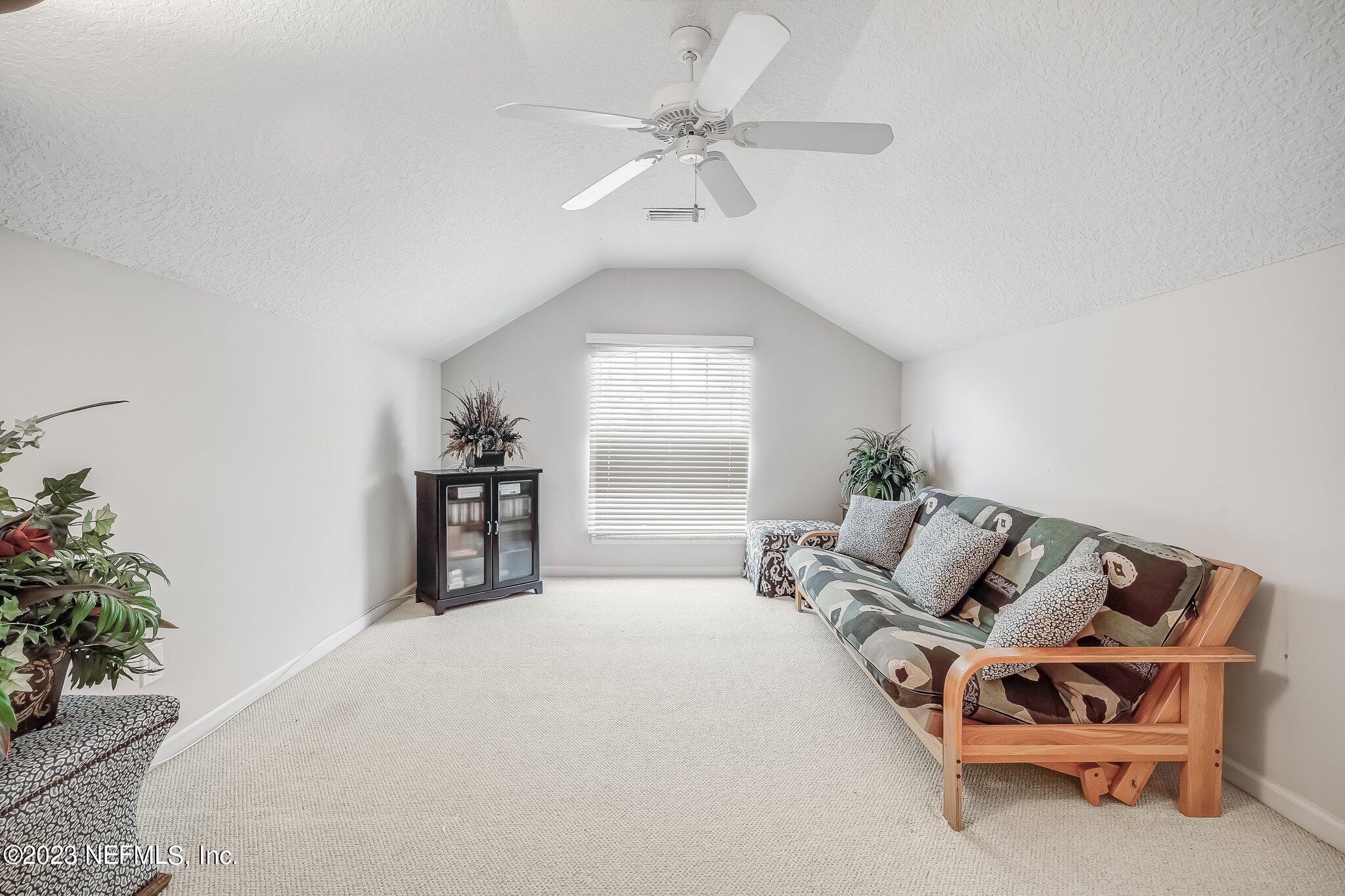 8026 Pine Lake Road Jacksonville, FL 32256 - Photo 31 of 43 a spacious bedroom with a bed and a chandelier