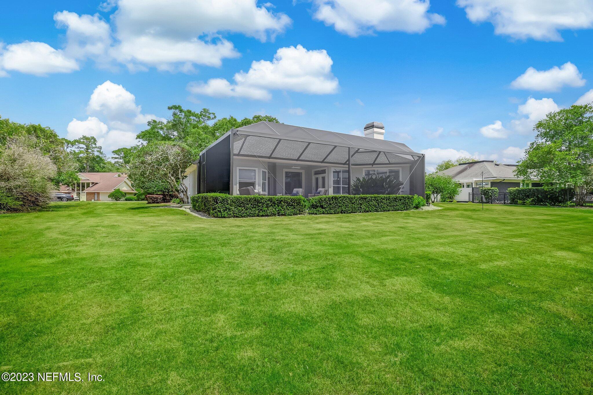 8026 Pine Lake Road Jacksonville, FL 32256 - Photo 34 of 43 a view of a big house with a yard and a garden