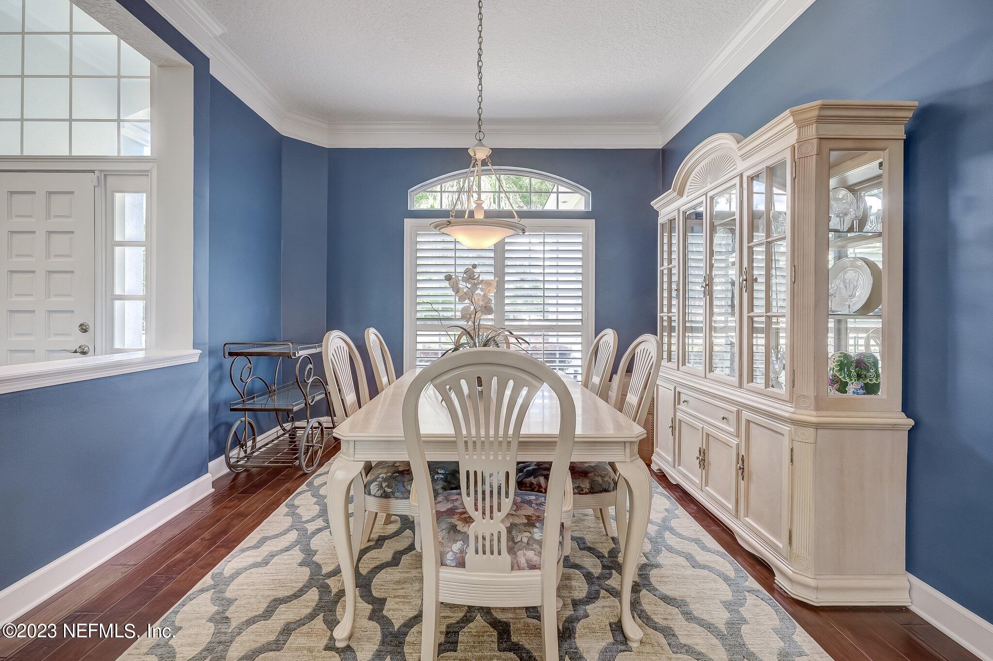8026 Pine Lake Road Jacksonville, FL 32256 - Photo 9 of 43 a view of a dining room with furniture a chandelier and wooden floor