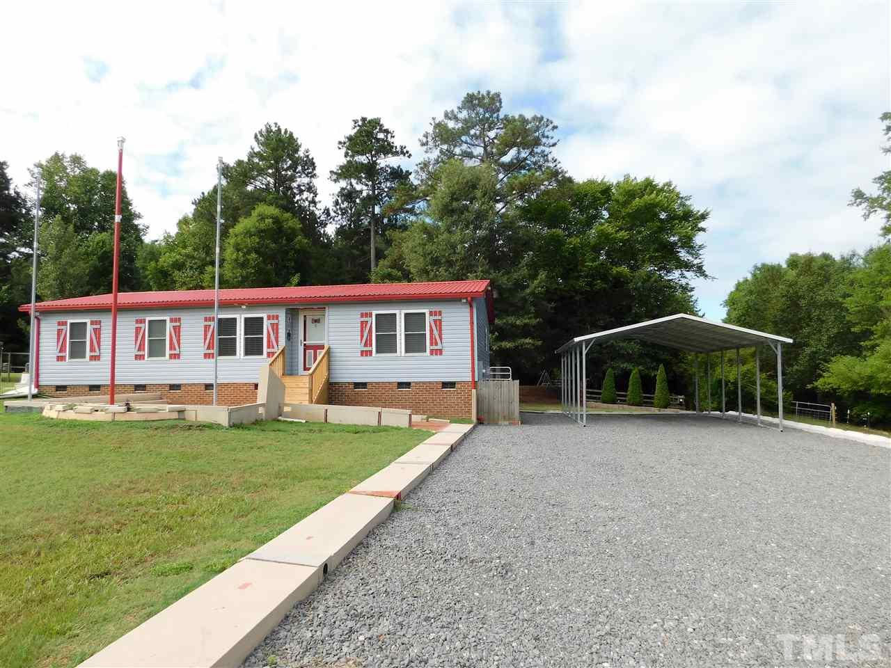 164 Clyde Pearce Road Zebulon, NC 27597 - Photo 1 of 25 a view of a house with a yard and sitting area