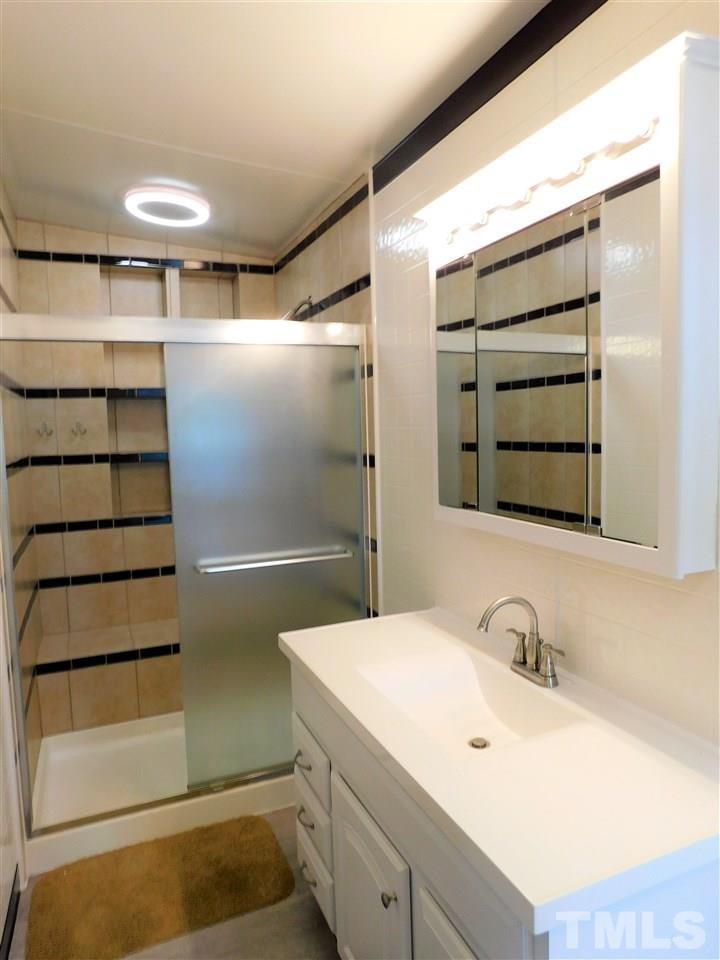 164 Clyde Pearce Road Zebulon, NC 27597 - Photo 14 of 25 a bathroom with a sink and a shower