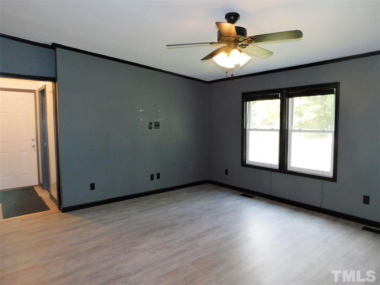 164 Clyde Pearce Road Zebulon, NC 27597 - Photo 22 of 25 wooden floor in an empty room with a window