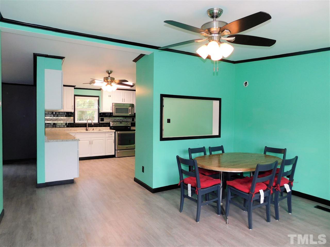 164 Clyde Pearce Road Zebulon, NC 27597 - Photo 7 of 25 a view of a dining room with furniture and a chandelier