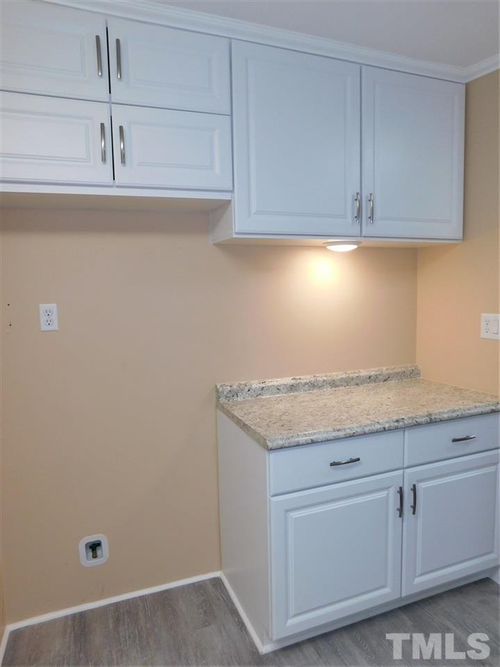 164 Clyde Pearce Road Zebulon, NC 27597 - Photo 8 of 25 a room with granite countertop cabinets and utility