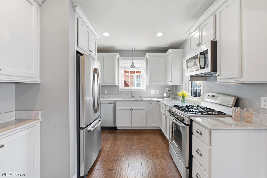 2552 Channing Road Cleveland, OH 44118 - Photo 6 of 33 Kitchen featuring marble counters, updated white cabinetry and stainless steel appliances.