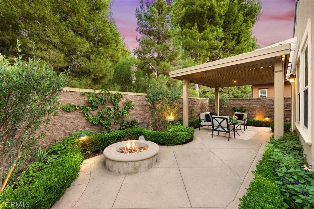 45 Shade Tree Irvine, CA 92603 - Photo 11 of 62 a view of a patio with table and chairs potted plants and a large tree