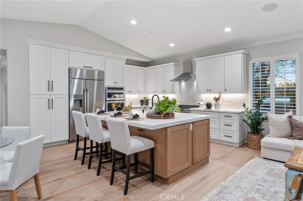 45 Shade Tree Irvine, CA 92603 - Photo 15 of 62 a kitchen with white cabinets and stainless steel appliances