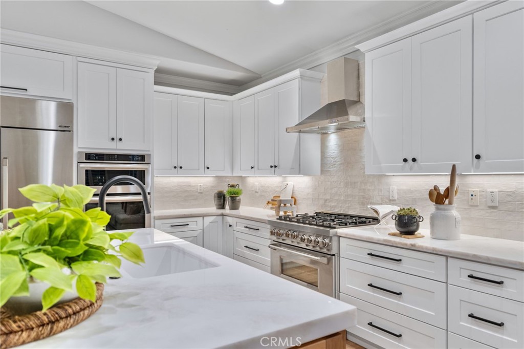 45 Shade Tree Irvine, CA 92603 - Photo 17 of 62 a kitchen with stainless steel appliances granite countertop a sink a stove and a refrigerator