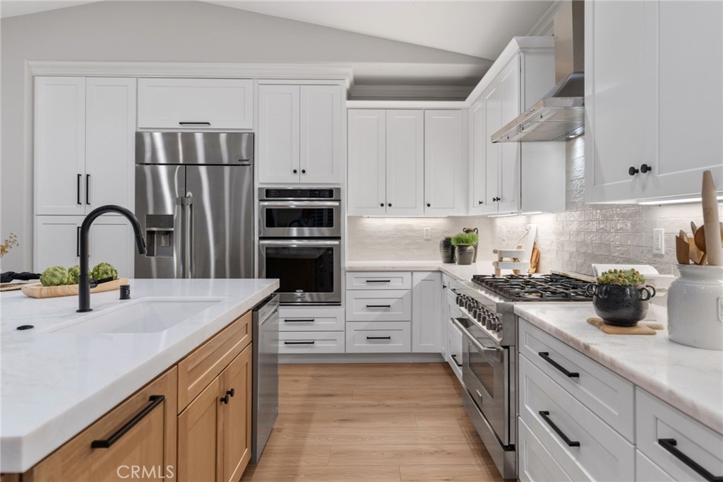 45 Shade Tree Irvine, CA 92603 - Photo 18 of 62 a kitchen with a sink a stove and refrigerator