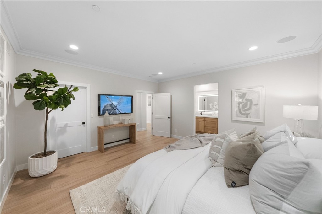 45 Shade Tree Irvine, CA 92603 - Photo 27 of 62 a bedroom with a bed and a potted plant