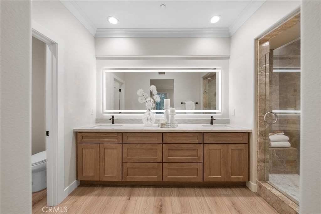 45 Shade Tree Irvine, CA 92603 - Photo 29 of 62 a bathroom with a double vanity sink and a mirror