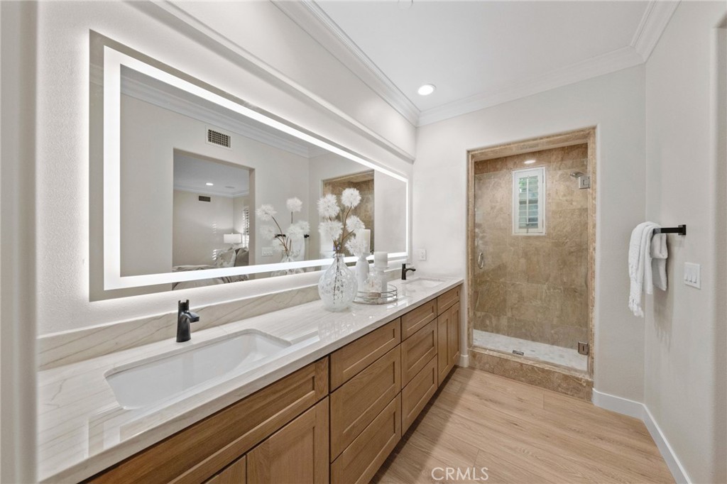 45 Shade Tree Irvine, CA 92603 - Photo 30 of 62 a bathroom with a double vanity sink and mirror