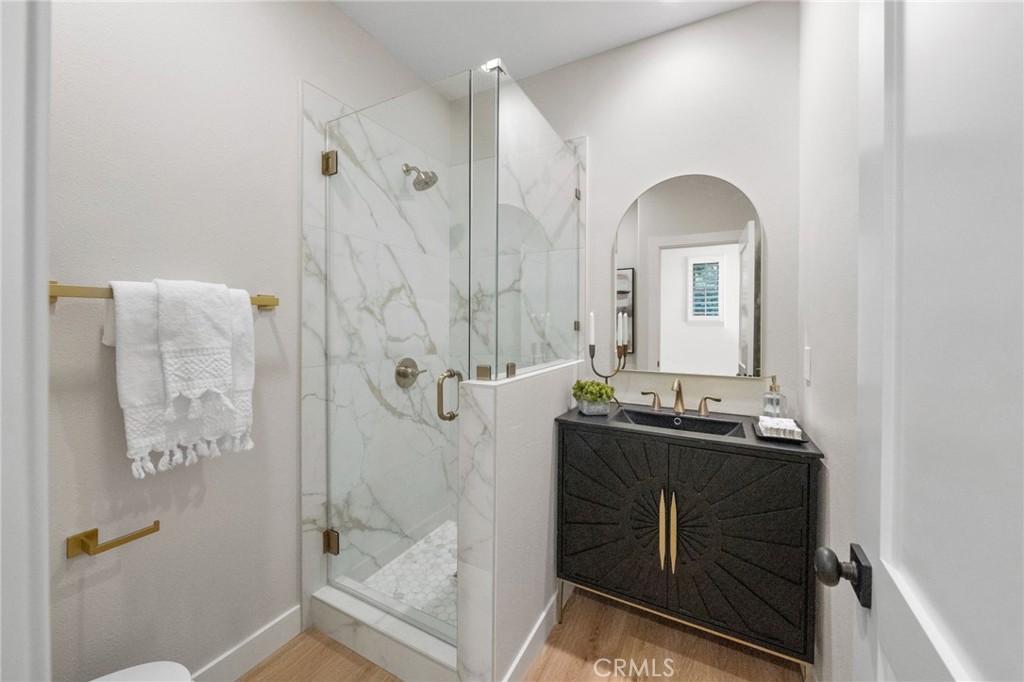 45 Shade Tree Irvine, CA 92603 - Photo 33 of 62 a bathroom with a double vanity sink a mirror and a shower