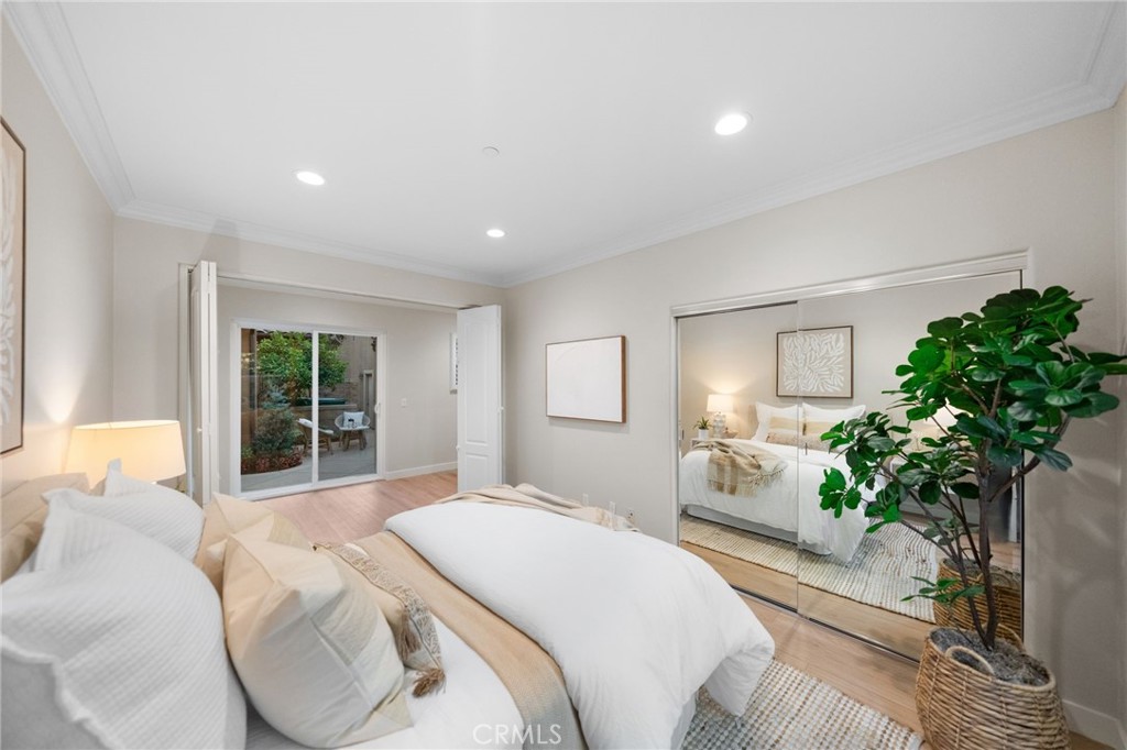 45 Shade Tree Irvine, CA 92603 - Photo 34 of 62 a bedroom with bed and a potted plant