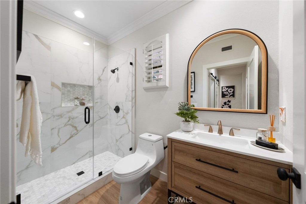 45 Shade Tree Irvine, CA 92603 - Photo 36 of 62 a bathroom with a sink a toilet and a mirror