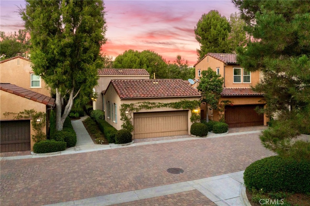 45 Shade Tree Irvine, CA 92603 - Photo 39 of 62 a front view of a house with a yard and garage