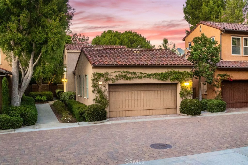 45 Shade Tree Irvine, CA 92603 - Photo 40 of 62 a front view of a house with a yard and garage