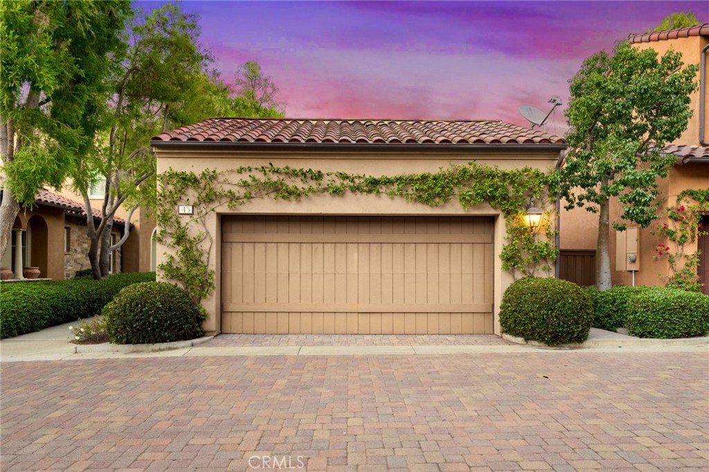 45 Shade Tree Irvine, CA 92603 - Photo 43 of 62 a front view of a house with a yard and garage