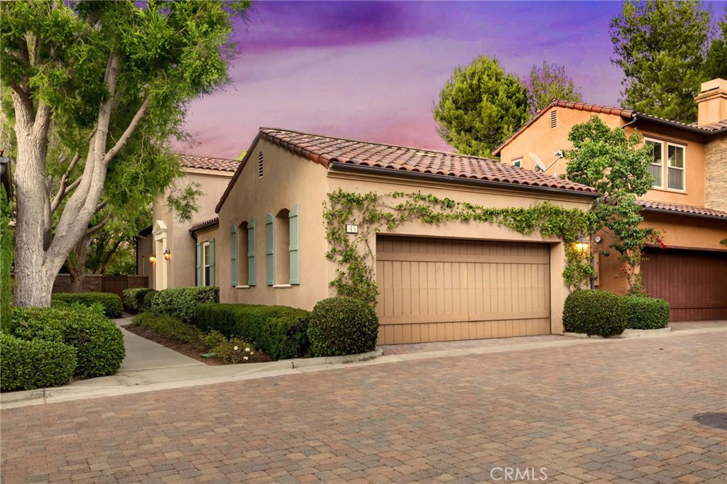 45 Shade Tree Irvine, CA 92603 - Photo 44 of 62 a front view of a house with a yard and garage