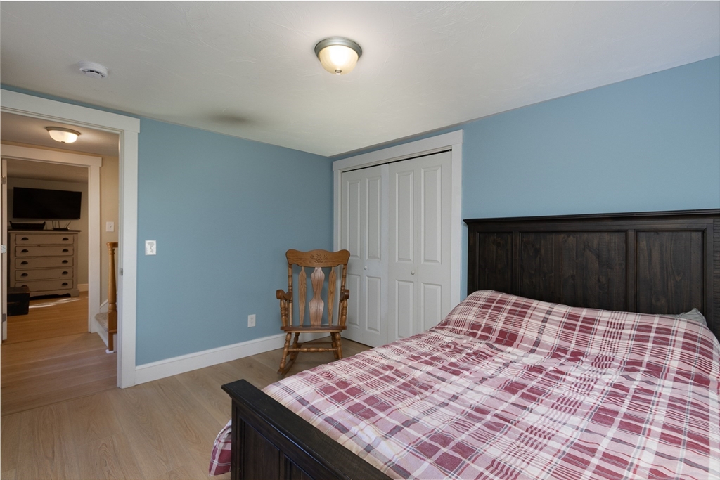 122 Wallace Road Sturbridge, MA 01566 - Photo 19 of 40 a bedroom with a bed and wooden floor