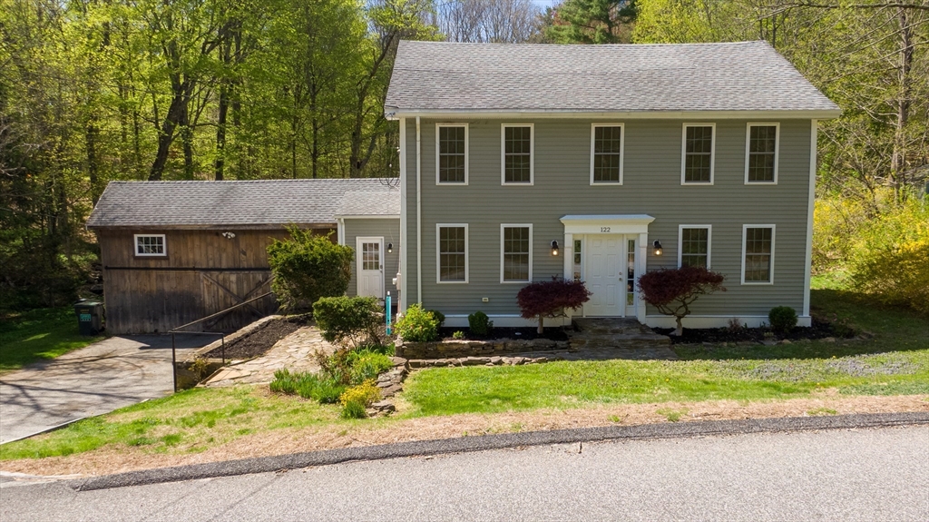 122 Wallace Road Sturbridge, MA 01566 - Photo 30 of 40 a front view of a house with a yard and outdoor seating