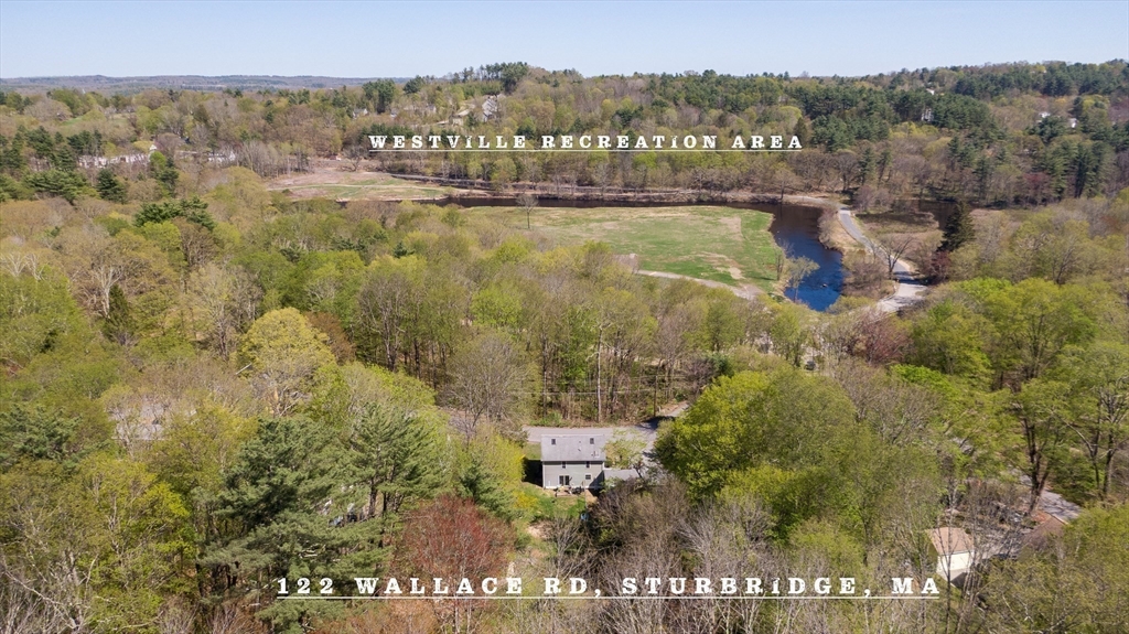 122 Wallace Road Sturbridge, MA 01566 - Photo 32 of 40 a view of a lake with a mountain in the back