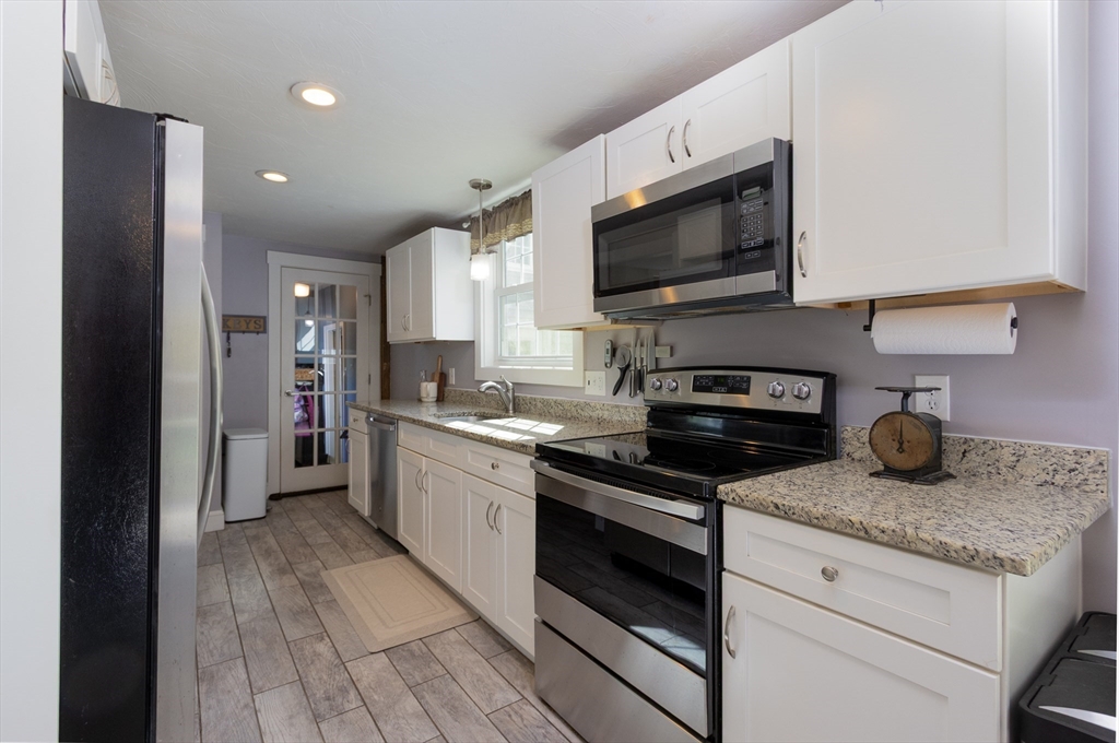 122 Wallace Road Sturbridge, MA 01566 - Photo 5 of 40 a kitchen with stainless steel appliances granite countertop a stove a sink and a refrigerator