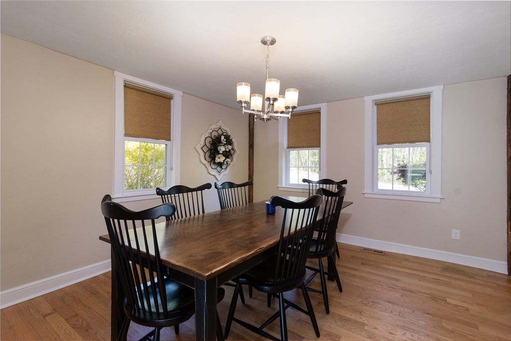 122 Wallace Road Sturbridge, MA 01566 - Photo 8 of 40 a view of a dining room with furniture a chandelier and wooden floor