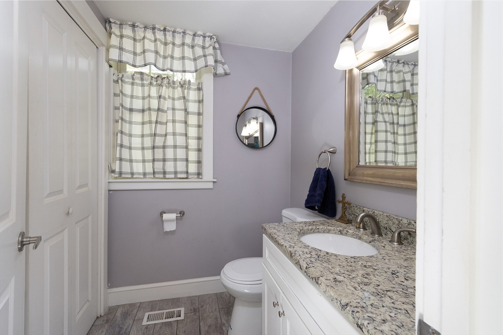 122 Wallace Road Sturbridge, MA 01566 - Photo 10 of 40 a bathroom with a granite countertop toilet sink and mirror