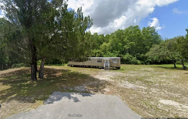 a house with trees in the background