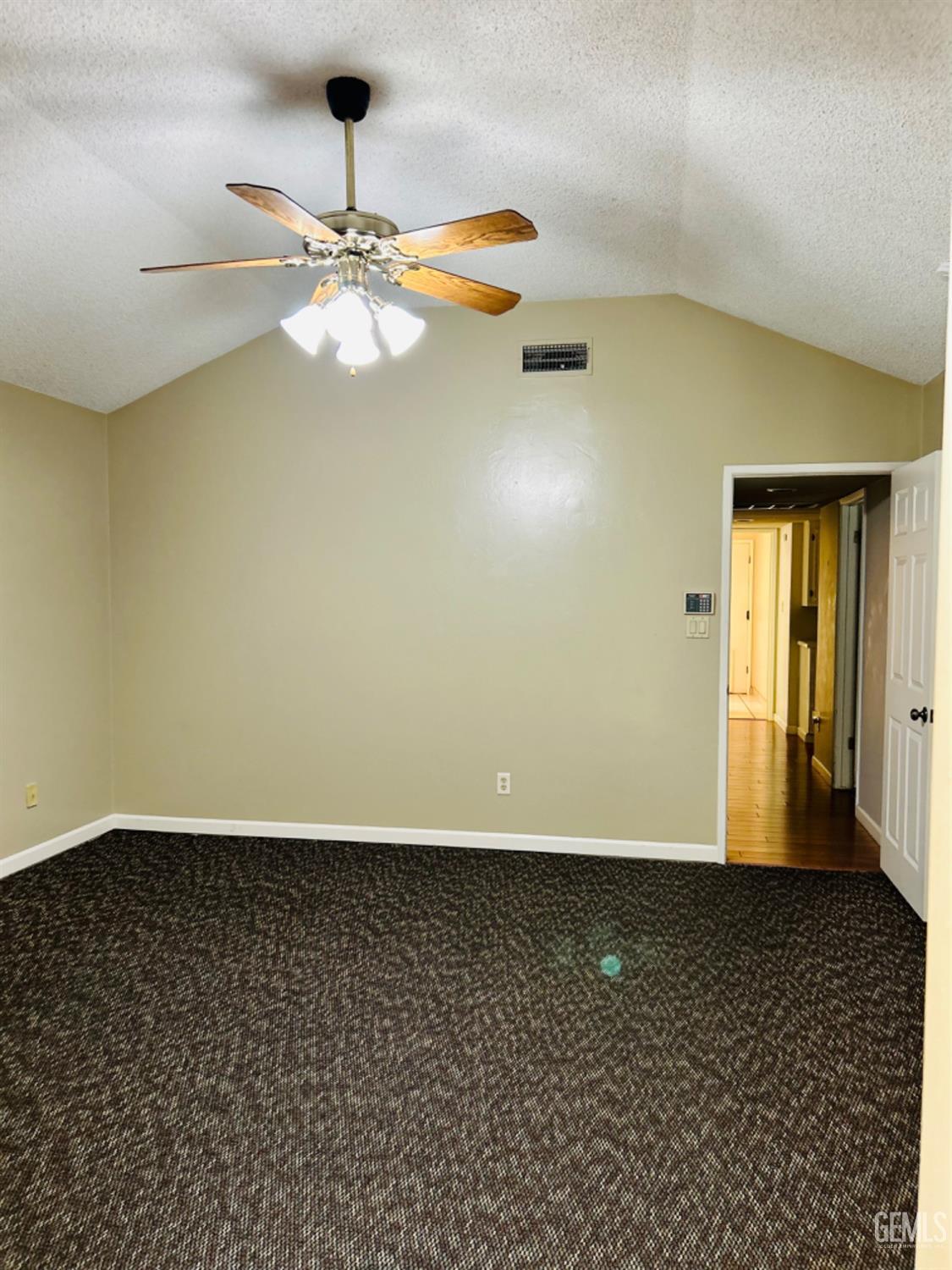Undisclosed Address Bakersfield, CA 93309 - Photo 12 of 14 wooden floor in an empty room with a chandelier