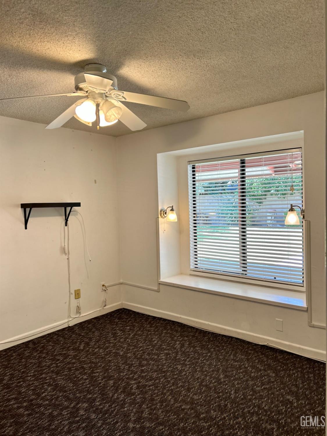 Undisclosed Address Bakersfield, CA 93309 - Photo 13 of 14 en empty room with windows and ceiling fan