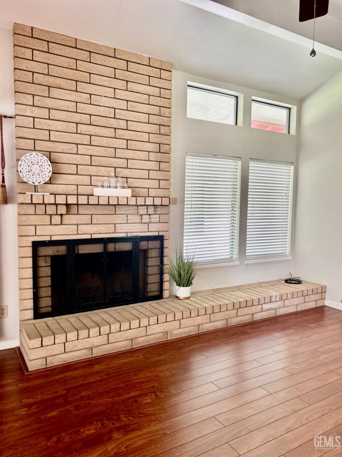 Undisclosed Address Bakersfield, CA 93309 - Photo 4 of 14 a living room with a wooden floor and a fireplace