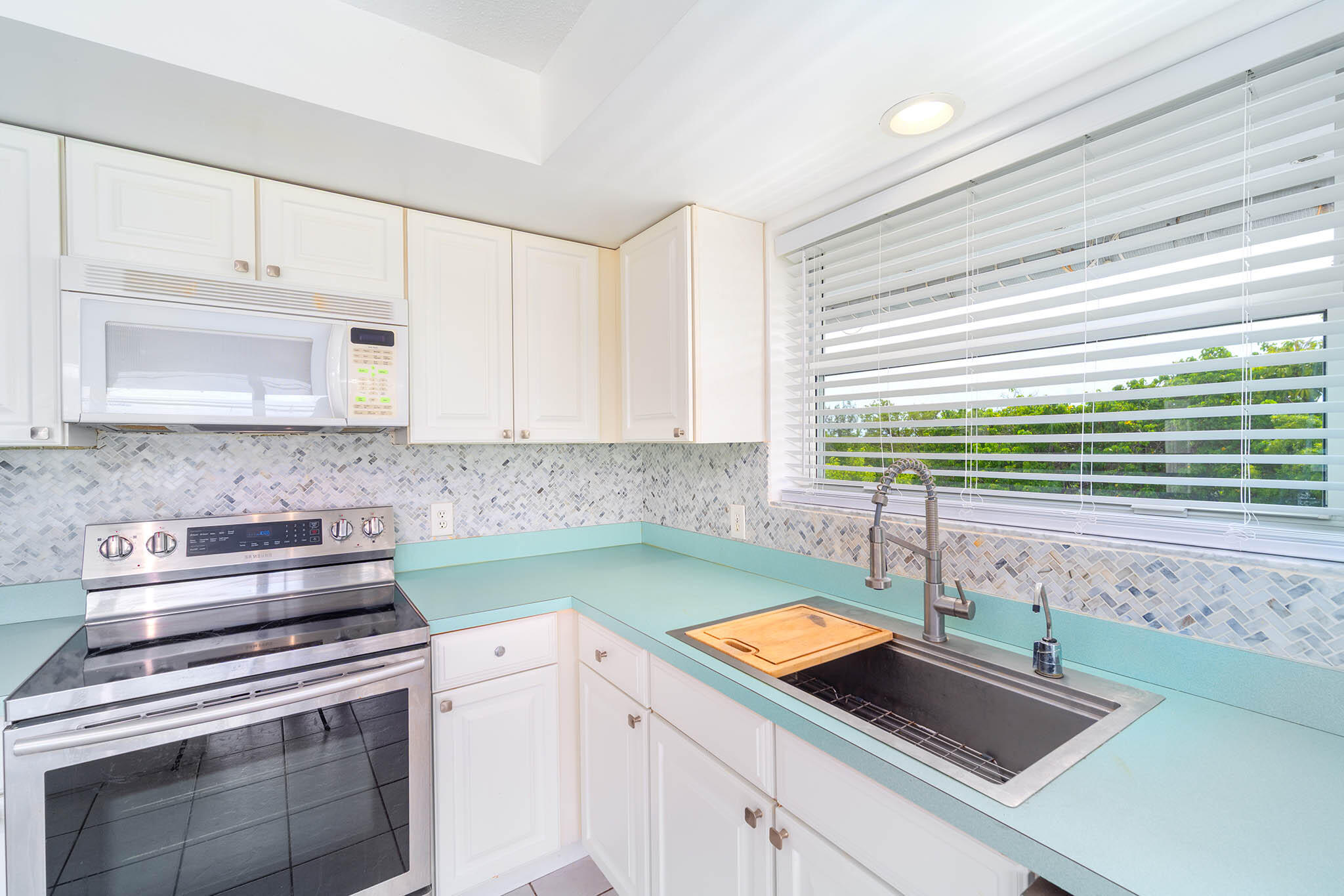 29849 Newfound Boulevard Big Pine Key, FL 33043 - Photo 9 of 25 a kitchen with a sink and cabinets