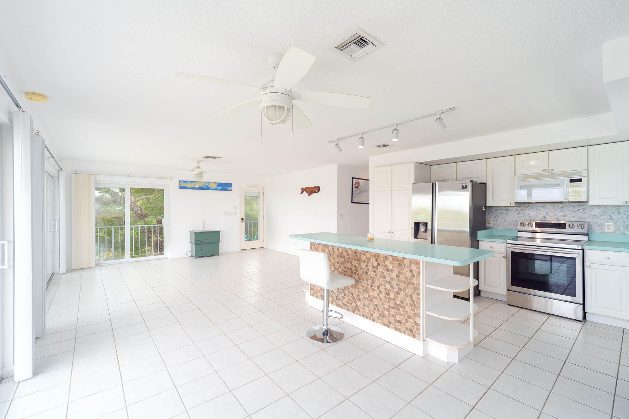 29849 Newfound Boulevard Big Pine Key, FL 33043 - Photo 10 of 25 a large white kitchen with cabinets