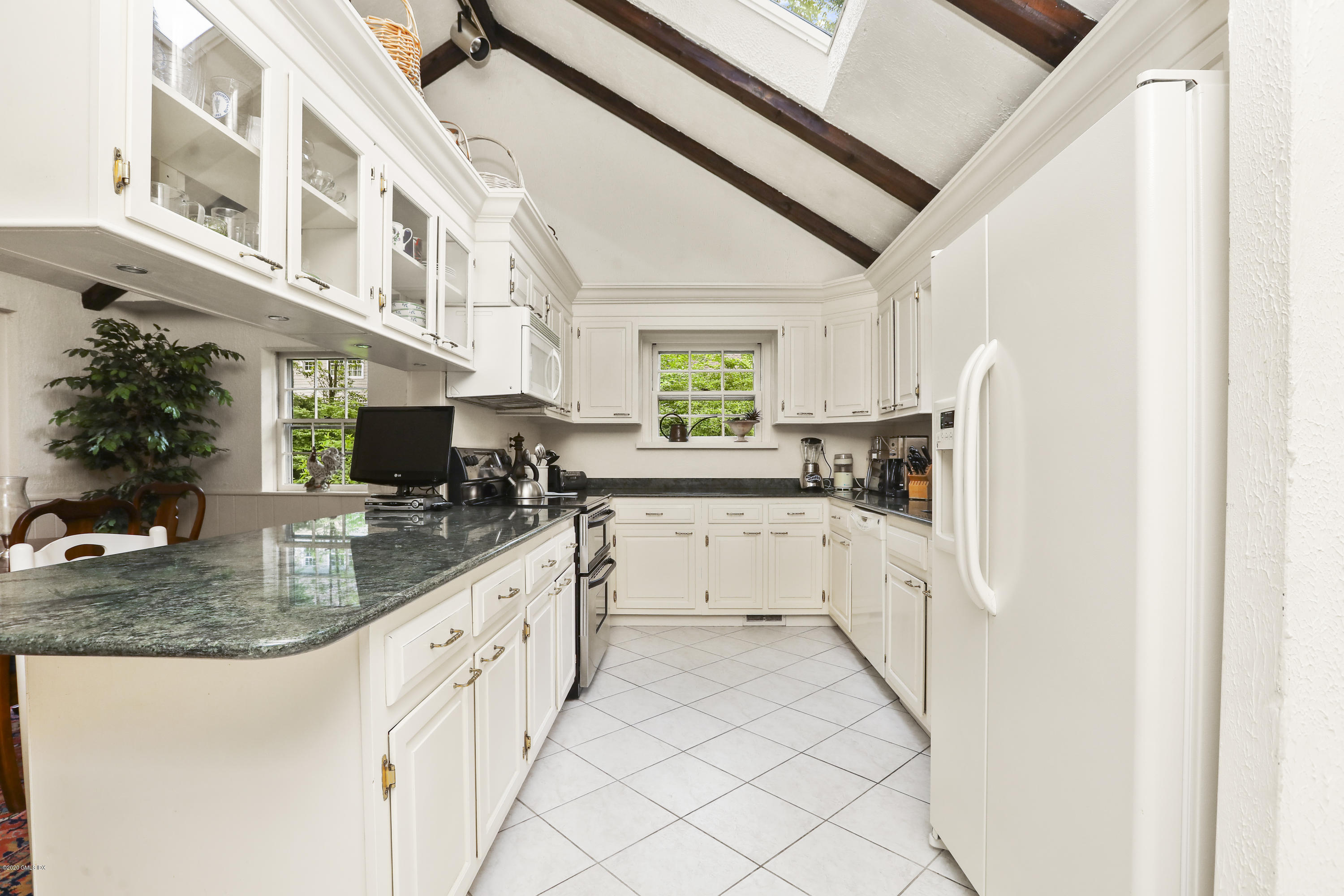 14 Hidden Brook Road Riverside, CT 06878 - Photo 9 of 13 a kitchen with white cabinets and white appliances