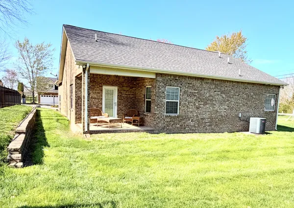 a view of a house with swimming pool and a yard