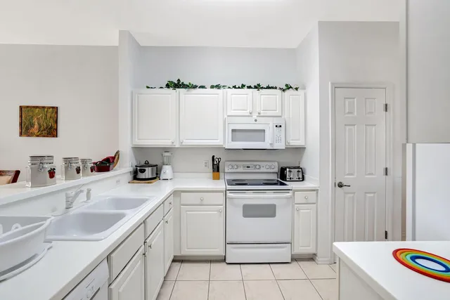 a kitchen with stainless steel appliances granite countertop a sink and a stove