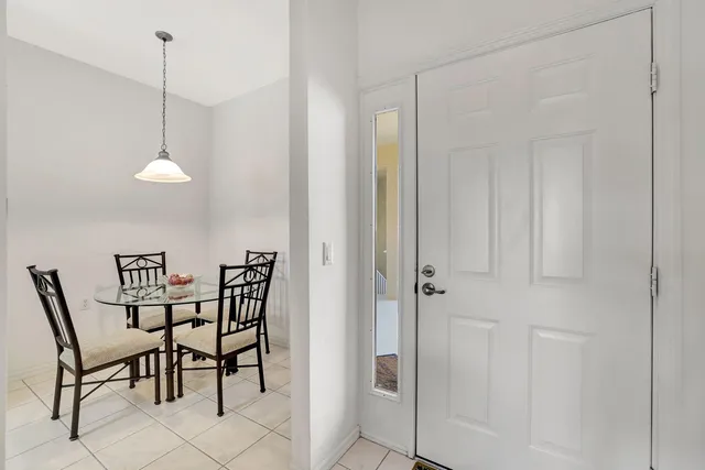 a view of a dining room and livingroom furniture wooden floor a chandelier