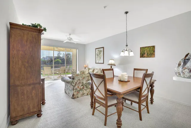 a view of a dining room with furniture large windows and wooden floor