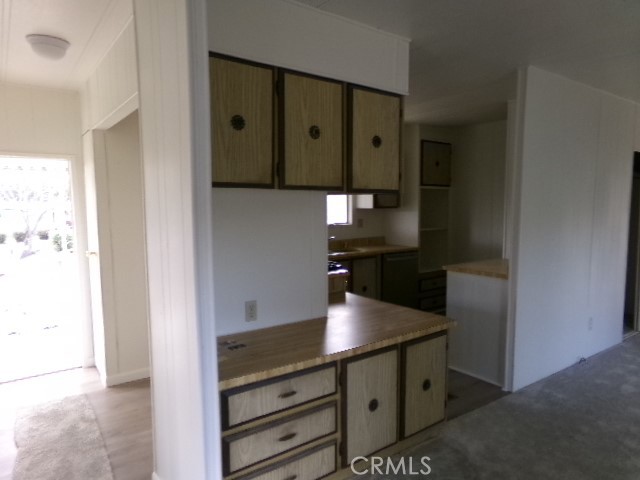 323 Ridgecrest Parkway Oroville, CA 95966 - Photo 12 of 35 a kitchen with stainless steel appliances a refrigerator and cabinets